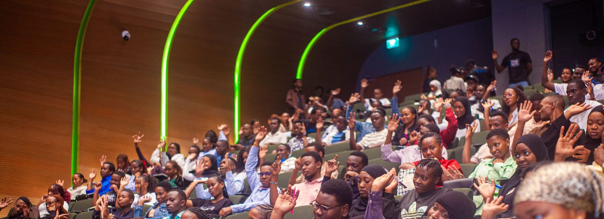Youth audience raising hands during a Digital Economy Africa engagement event