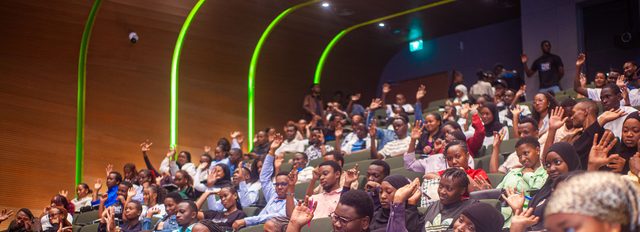 Youth audience raising hands during a Digital Economy Africa engagement event